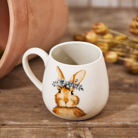 White ceramic mug featuring a brown hare with spring flowers around its ears