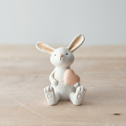 Ornament of a white rabbit, holding a sweet pink heart.